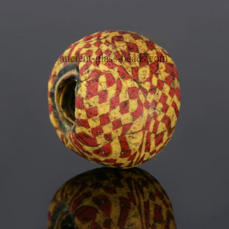 Ancient mosaic glass bead with checkerboard red and yellow pattern